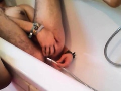 Bi-guy using shower head, squirting water, enema