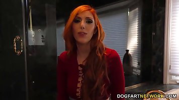 Red haired woman, Lauren Phillips is sucking a big, black cock through a gloryhole, just for fun