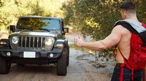 Ripped and shirtless hitchhiker is lookin' for a ride