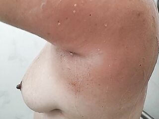 The wife soaping up her titties in the shower