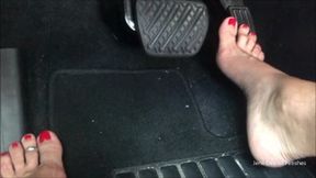 Driving with red toenails floor view_