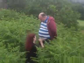 Fat fellow's cock sucked by a babe on a field