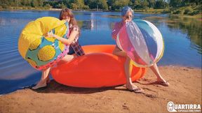 Q886 Cosette and Stashia blow two big beach balls on a lake - 1080p