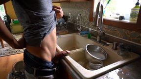 Instead of cleaning the dishes dirty boy empties bladder in the kitchen sink