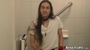 Long haired stud working on his cock on the bathtub