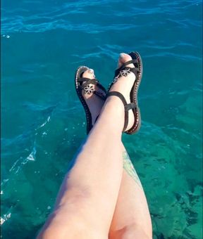 Dominatrix excites you with her feet on the sea