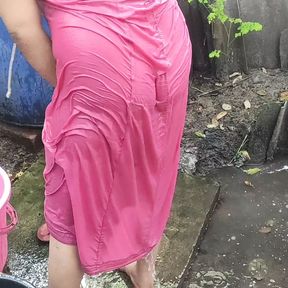 Indian house wife bathing outside