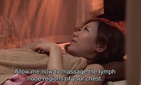 Busty Asian MILF gets oiled up in a Japanese massage clinic