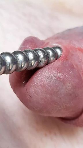 Sounding with a close up cum load through penis plug