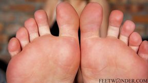 She takes her stinky socks and sneakers and shows her soles