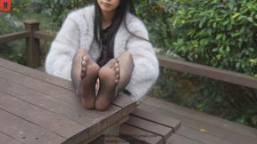 Tall attractive college girl Tai Mei wearing sexy black ultra-thin pantyhose and cheongsam showing her beautiful legs and feet on a wooden table in the park