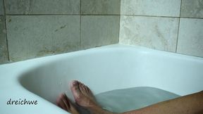 feet warm in a bathtub with soap