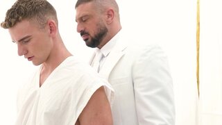 A man in a suit is banging the hell out of a petite lad