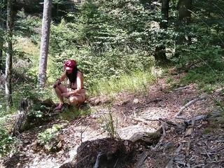 Milf woman with big tits jerking fat dick in the woods