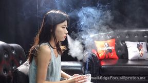 Asian Woman Exhaling Thick Cigarette Smoke Clouds on Leather Couch 4K