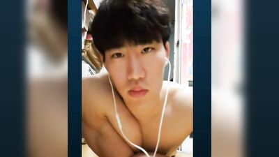 Handsome Korean bloke is posing naked in front of the camera