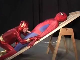 Superhero attired studs sucking cock
