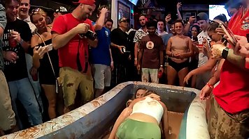 Hot babes are wrestling in the pudding while guys are watching them and enjoying it