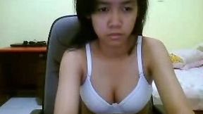 Petite Asian girl takes off her bra but still hides her titties