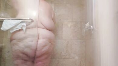 Watch the fat goth girl wash her huge belly in the shower