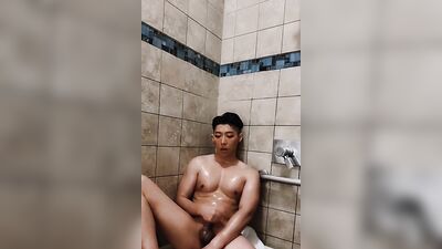 Horny Asian college jock plays with dildo in risky public shower