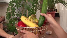 Three lesbians are playing with a cucumber
