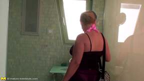 Brunette mature gets pissed on in a restroom