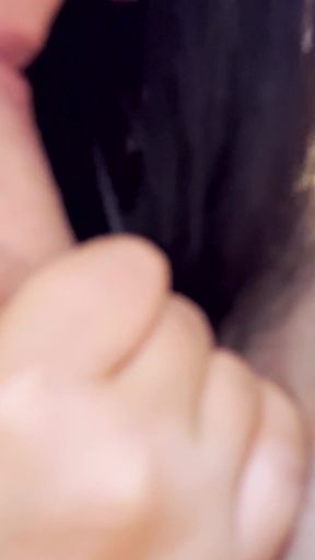 A girl with a tattoo on her arm licks her boyfriend's dick at home