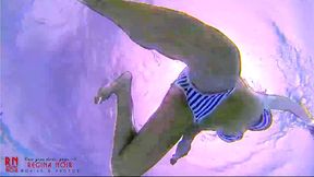 Amazing underwater bikini show. Elegant flexible babe swims