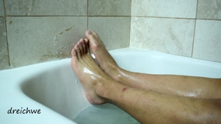 Feet warm in a bathtub with soap