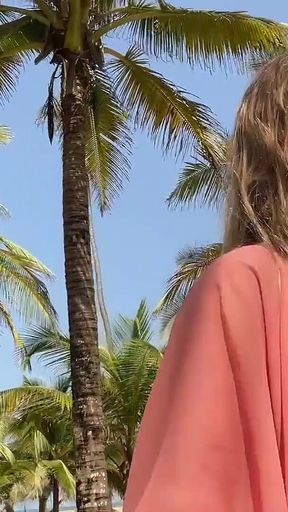 A Busty Blonde Woman Is Walking Around and Showing Her Naked Body on the Beach.