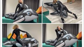 Alina inflates a big whale and rides it
