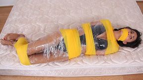 Swimsuit Clad Babe Gia Mancini Is Coiled In Plastic And Bright Yellow Bandages!