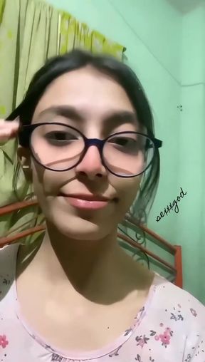 Woman in glasses smiling at camera