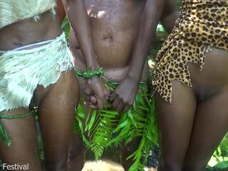 2 African tribe girl having fun with the village chief in the middle of the forrest