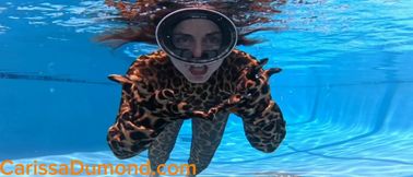 Carissa in the leopard catsuit swimming in the pool with bound ankles