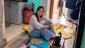 Indian wife sewing on the machine but she has other thoughts too.