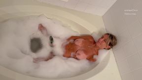 Dianne Fox in the tub with a cucumber.