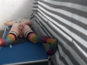 Caged sissy plays with her dildo on public balcony