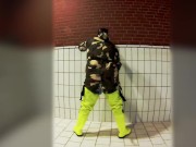Pawing off in camo painter's overall and hi-viz waders