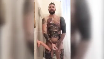 Tatted Hunk Fucks Dildo in Shower Until He Cums