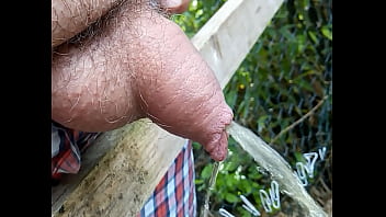 Soft uncut cock pissing outdoors close up