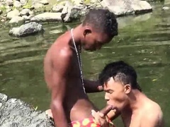 Teen gay swimmer playfully going down in the river