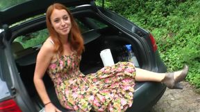 Redhead enjoys masturbation in trunk