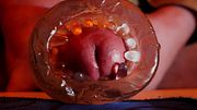 A close-up of a dick cumming in your ass