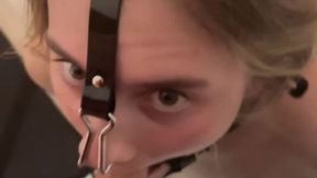 Blowjob with ring gag, nipple clamps and inflatable collar