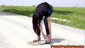 After a long trip Mary'_s bladder is bulging and she can hardly hold it, she is trying to pee in a wheatgrass field