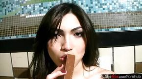 Cuddly teen tranny compares her cock size to chocolate stick