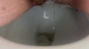 Close up desperate pee in to toilet