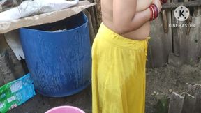 Indian woman bathing outside